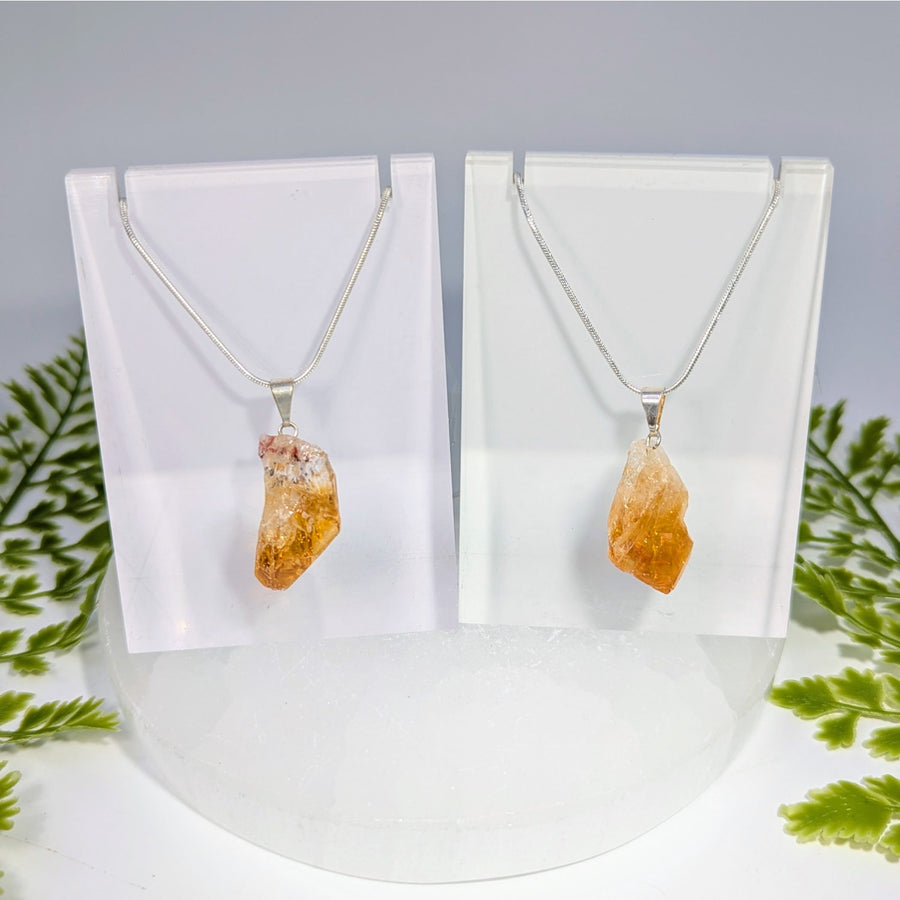 Two citrine point rough pendant necklaces with raw orange-yellow crystals on delicate silver chains for jewelry