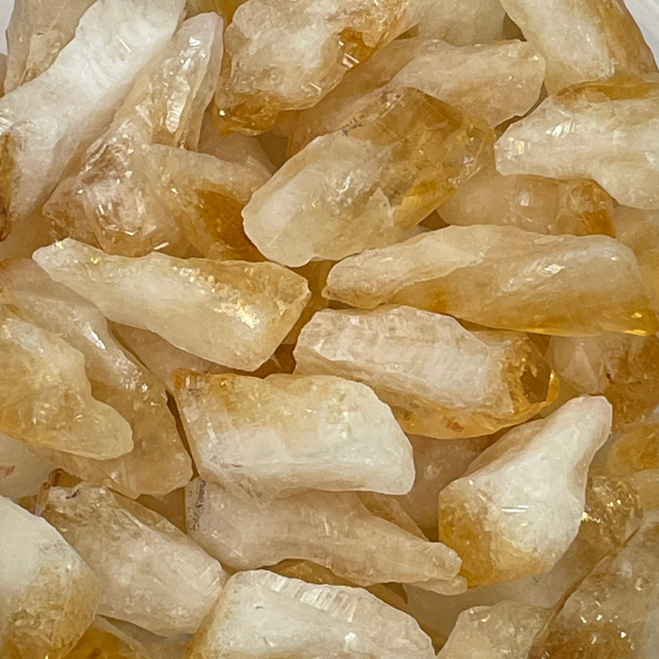 Pile of raw citrine quartz crystals showing citrine rough point for jewelry making