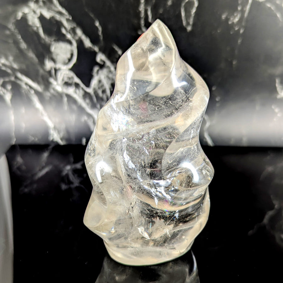 Clear quartz 5.6 inch flame sculpture with a twisted organic shape and natural internal inclusions