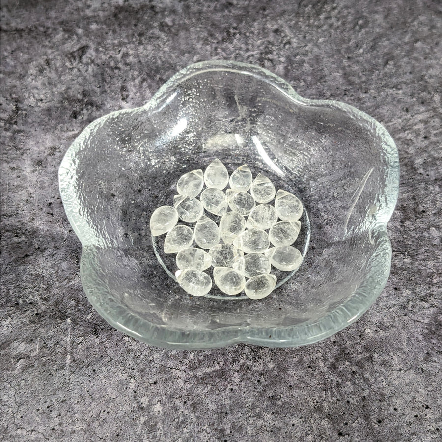A glass bowl filled with ice showcasing Clear Quartz 6mm Briolette Beads #LV3641