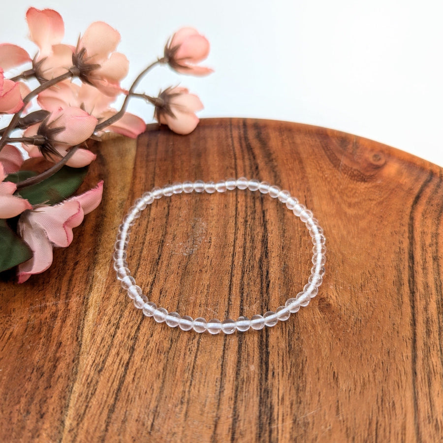 Clear quartz beaded bracelet with 7-inch length and 4mm beads displayed on product page
