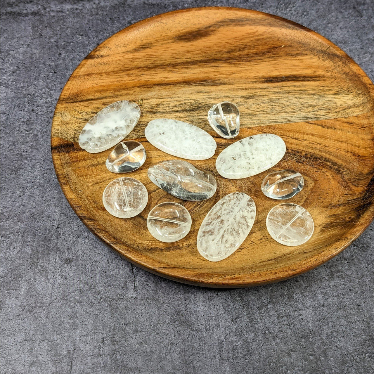 Wooden plate with white and clear quartz stones, featured in Clear Quartz Bead Assorted Pack #LV3639