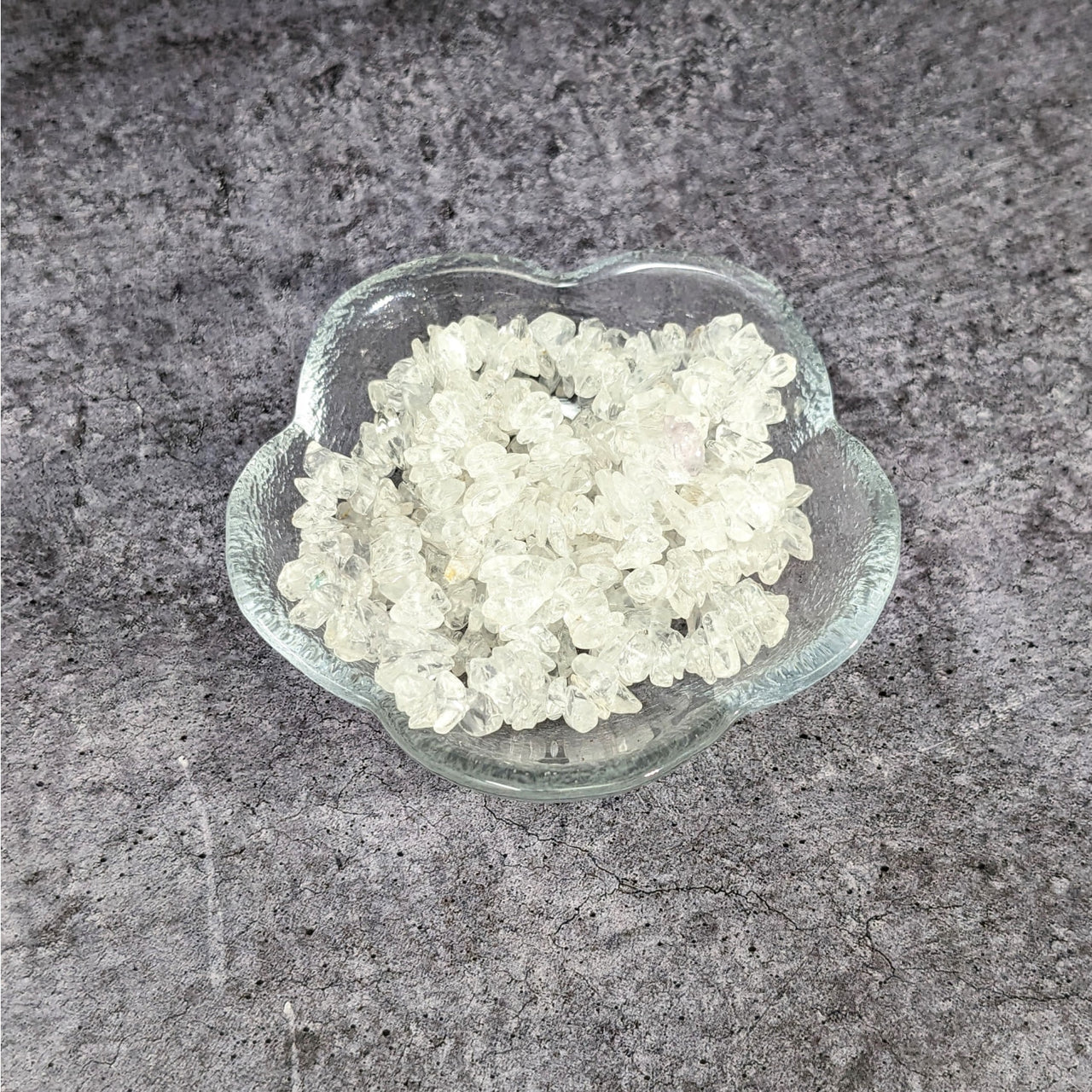 A bowl of white sugar on granite counter showcasing Clear Quartz Chip Bead Assorted Size