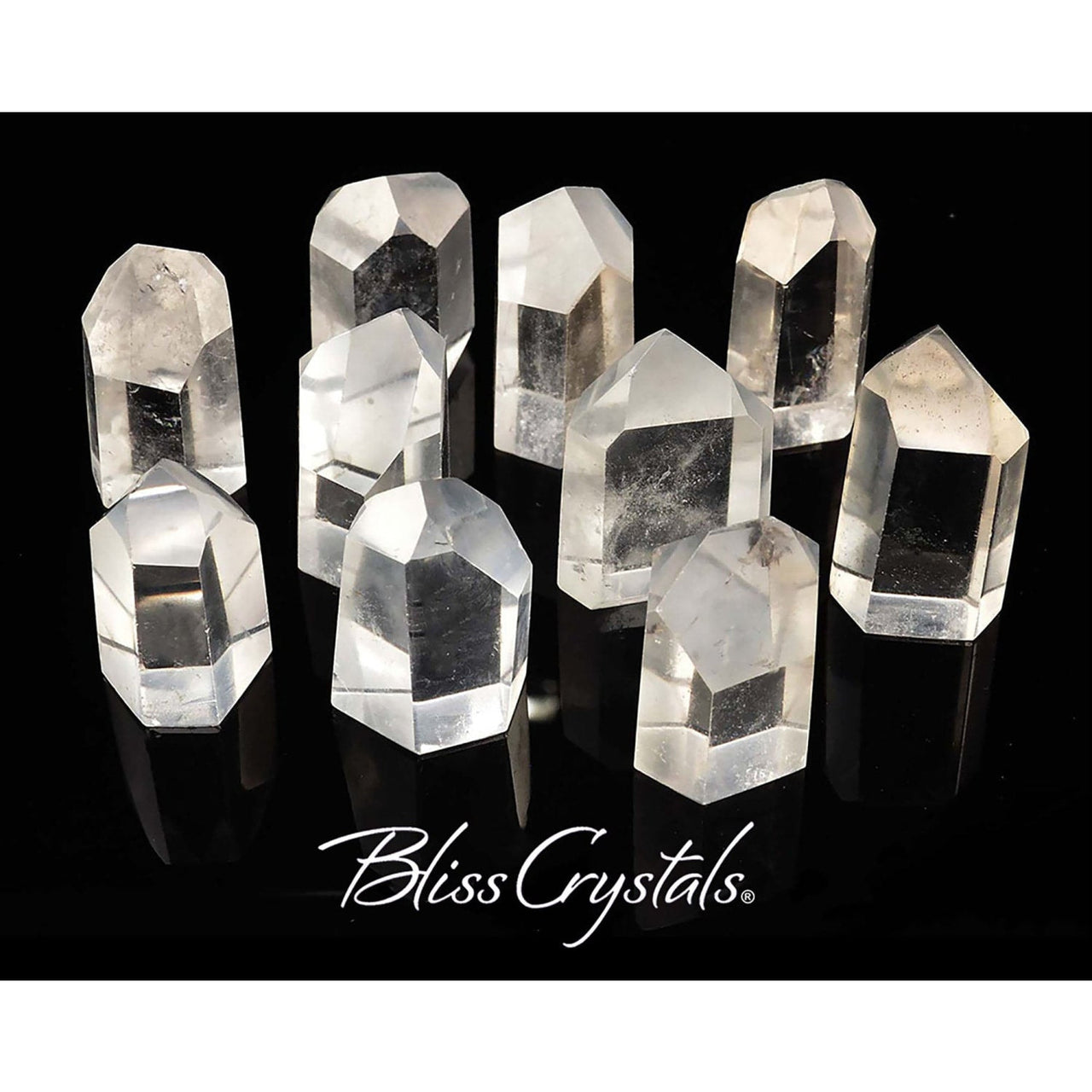 Clear quartz generator points arranged with Bliss Crystals text below for energy healing