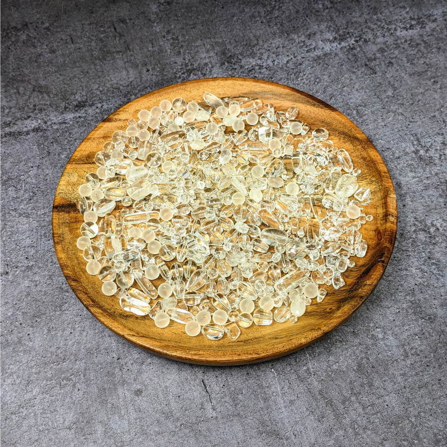 Wooden bowl of sunflower seeds displayed with Clear Quartz Mixed Beads Assorted Size Pack #LV3645