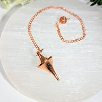 Rose gold-toned copper metal 1.5 inch pendulum with faceted pointed design and chain ideal for crystals and gemstones jewelry