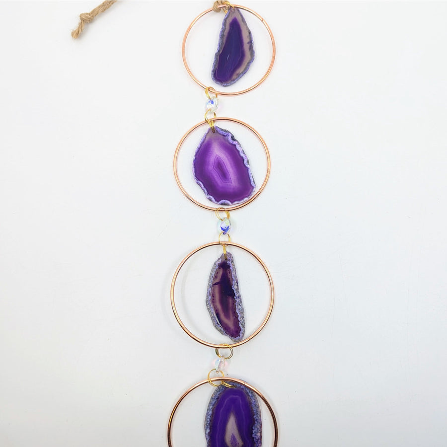 Purple agate slice wind chime reflected in Copper Ring 32 inch Agate Prism Suncatcher