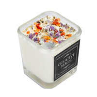 Creative Magic soy crystal ritual candle with purple orange clear fragments in white wax vessel