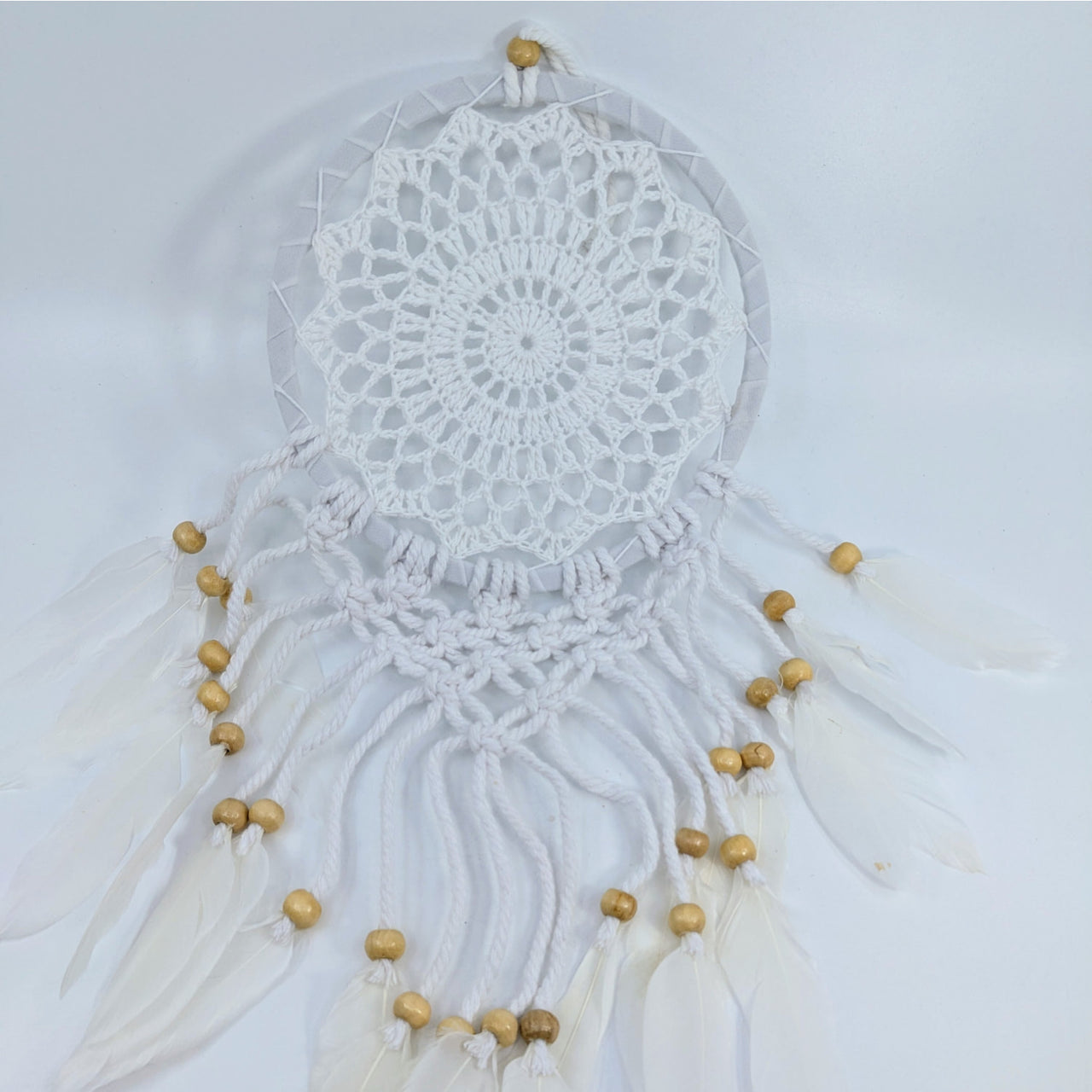 White crocheted dreamcatcher with beads and feathers, perfect for referral history rewards