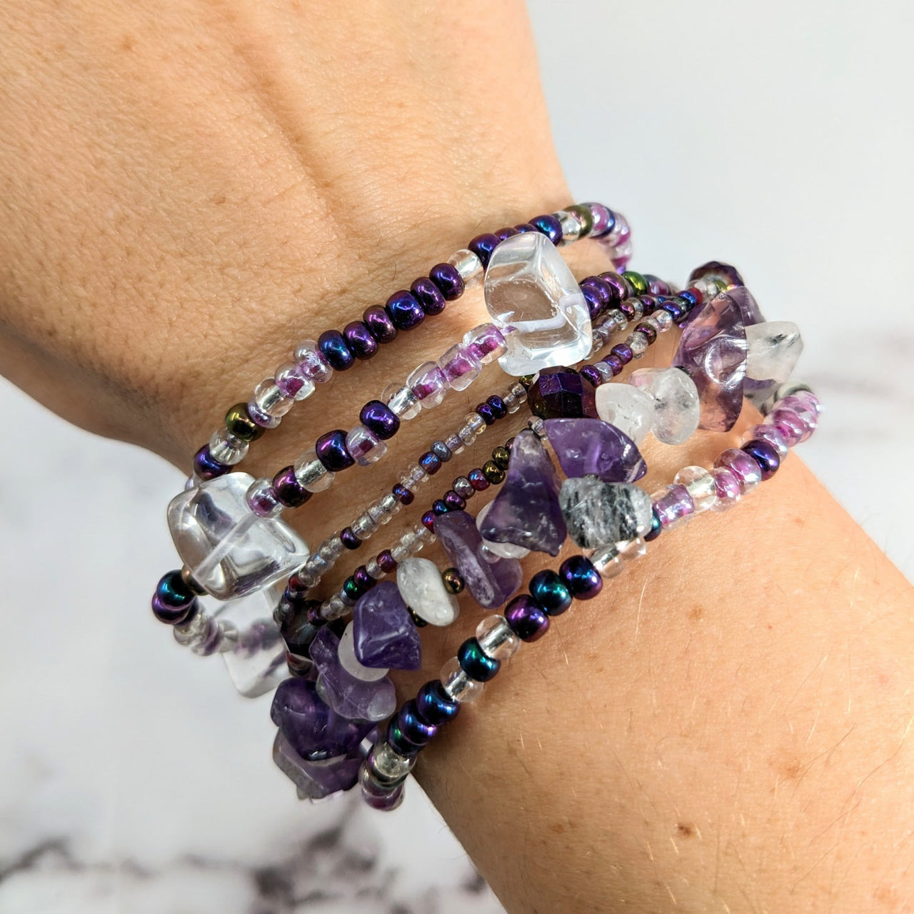 Woman wearing Crystal Beaded Bracelet with purple, white beads, 7.5’ Magnet Clasp #LV1779