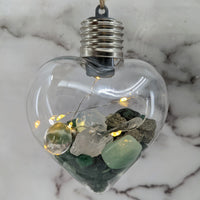 Thumbnail for Heart-shaped glass light bulb filled with stones and fairy lights in Crystal Heart Ornament