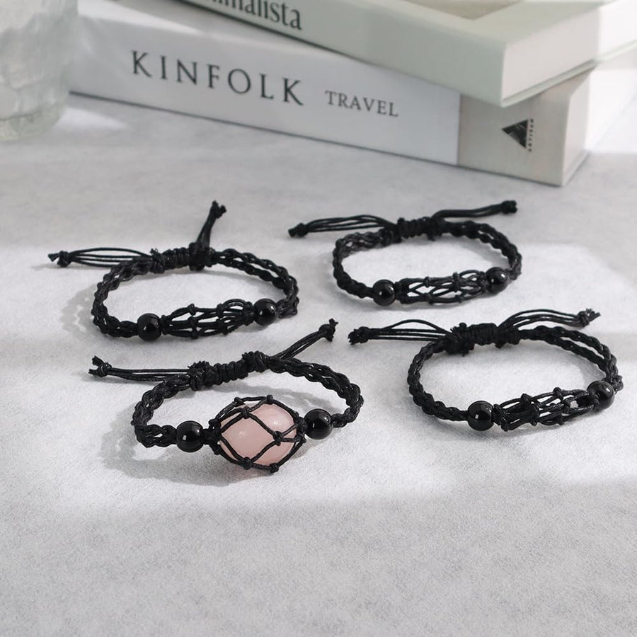 Four black braided string bracelets with a pink crystal from the Crystal Holder Necklace