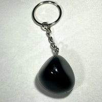 Black teardrop-shaped crystal keychain with smooth glossy finish and silver metal chain and ring for everyday use