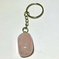A smooth translucent pink rose quartz keychain with a metallic chain and ring for crystal keychain assorted q106