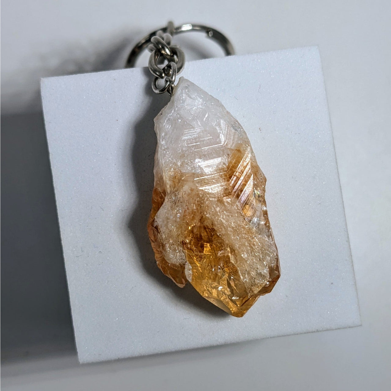 A translucent golden-yellow citrine crystal keychain with a silver-toned metal ring and chain from crystal keychain assorted q106