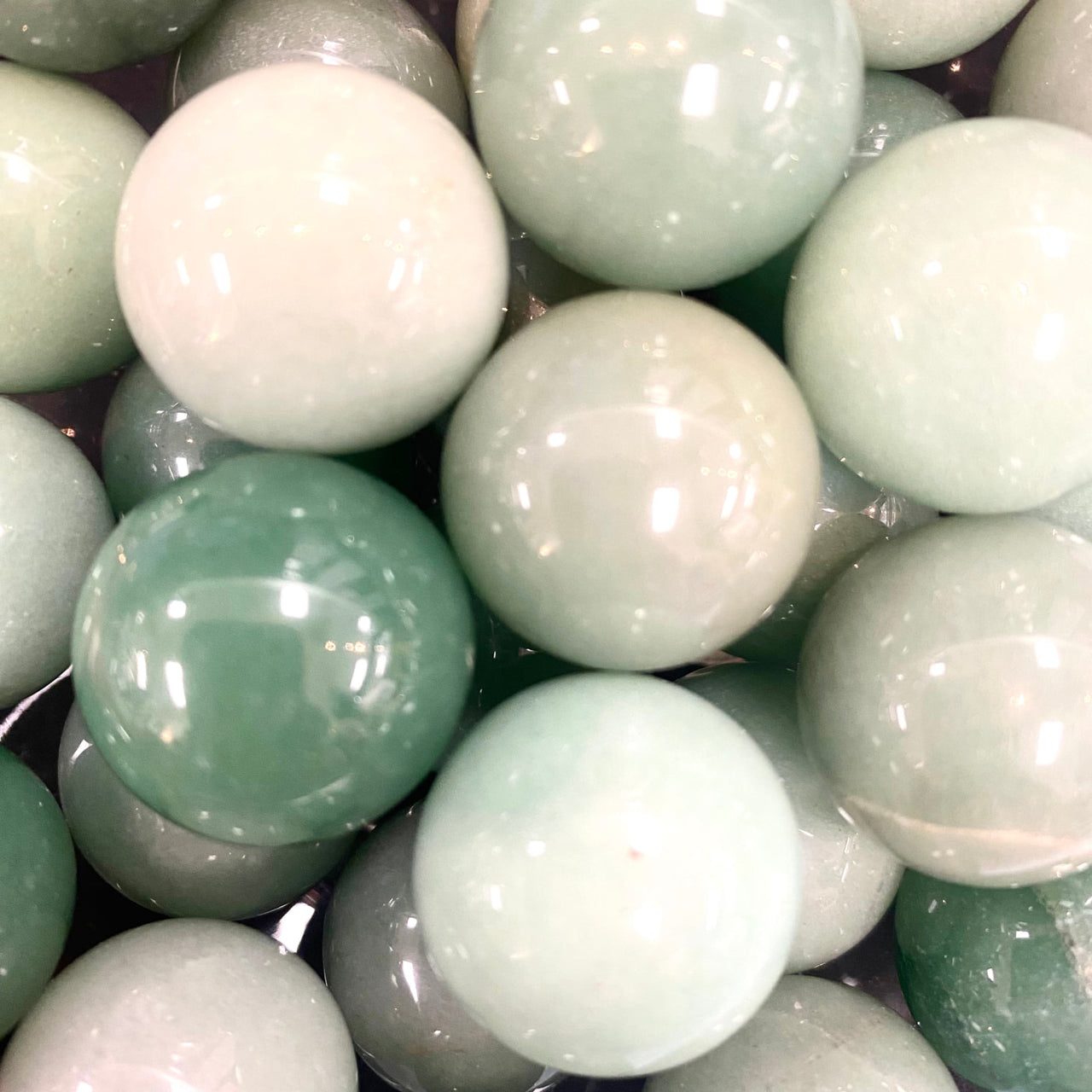 Smooth polished jade and white marbles clustered, perfect for rose quartz decor