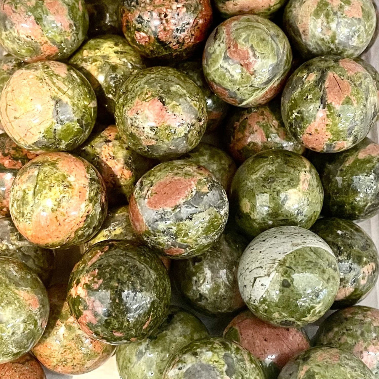 Polished spherical Unakite stones with rose quartz patterns in Crystal Marble S015