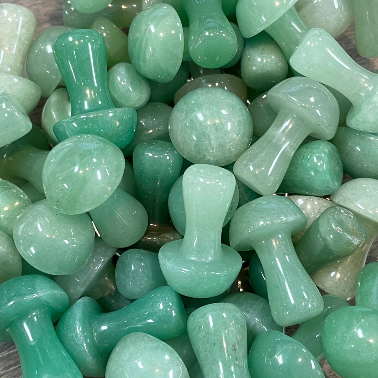 Polished green aventurine crystal mushroom carvings in Crystal Mushroom C041 display