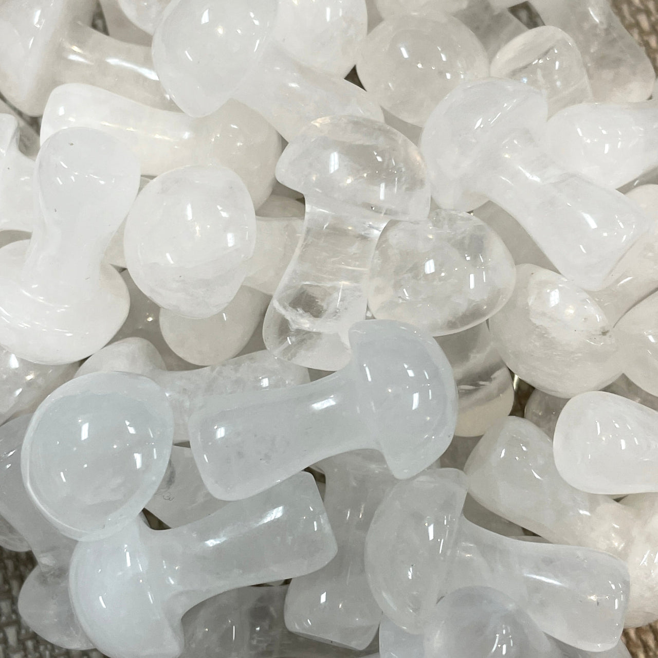 Clear plastic pacifiers in a pile, showcasing the Crystal Mushroom C041 product