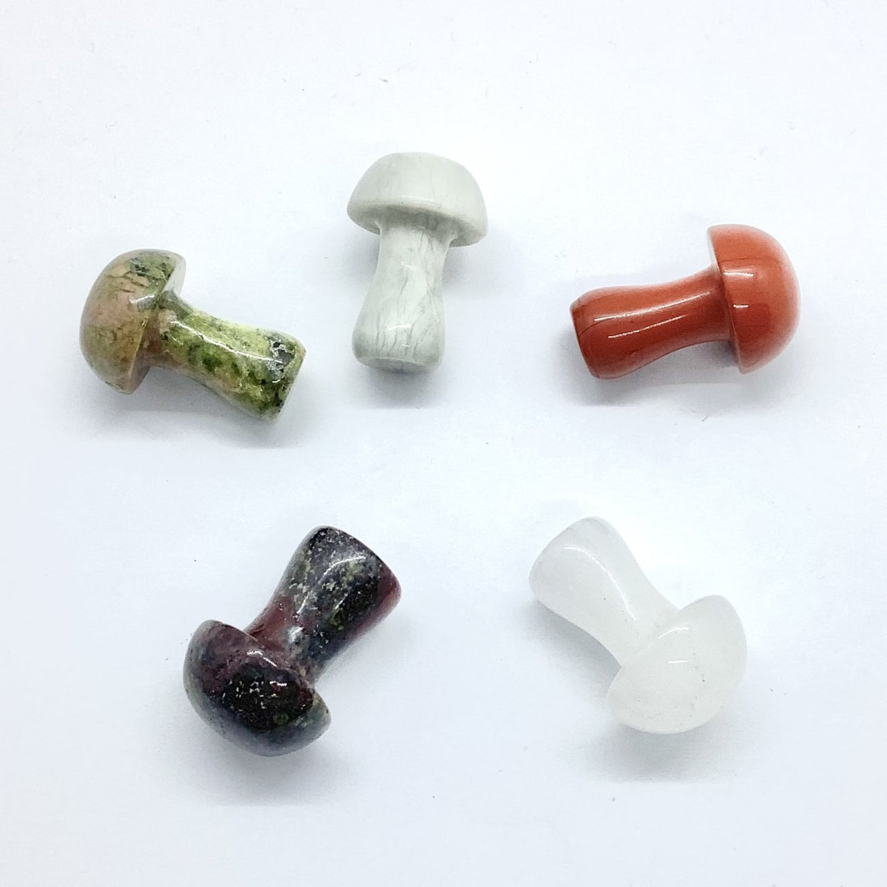 Five colorful mushroom-shaped stones arranged in a circle for Crystal Mushroom C041