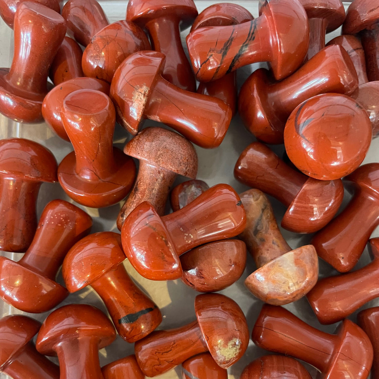 Collection of polished red jasper stones shaped like mushrooms in Crystal Mushroom C041