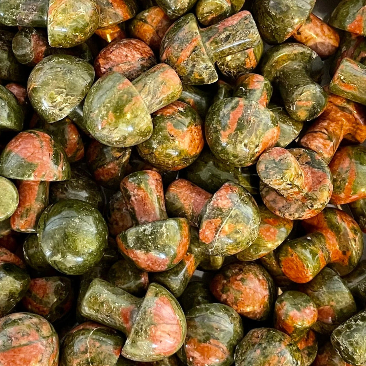 Pile of weathered stones with green and orange-pink hues in Crystal Mushroom C041