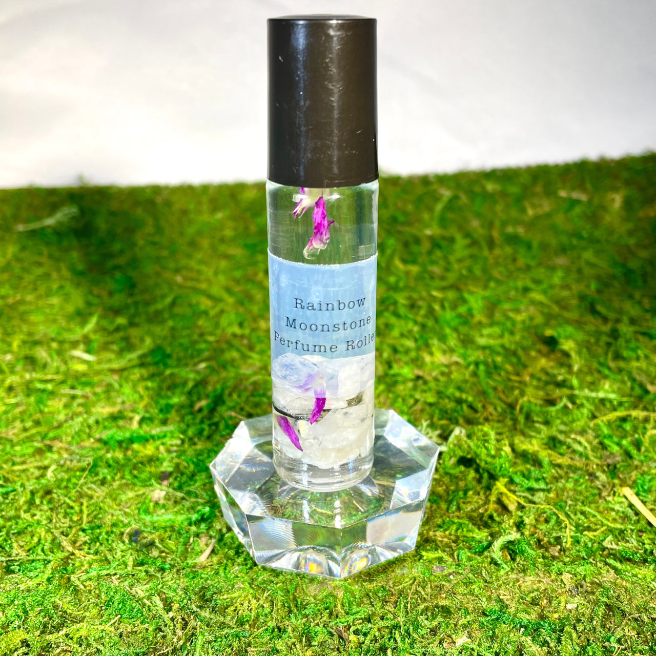 Bottle of Crystal Perfume 10ml Roller #Q217 on green grass