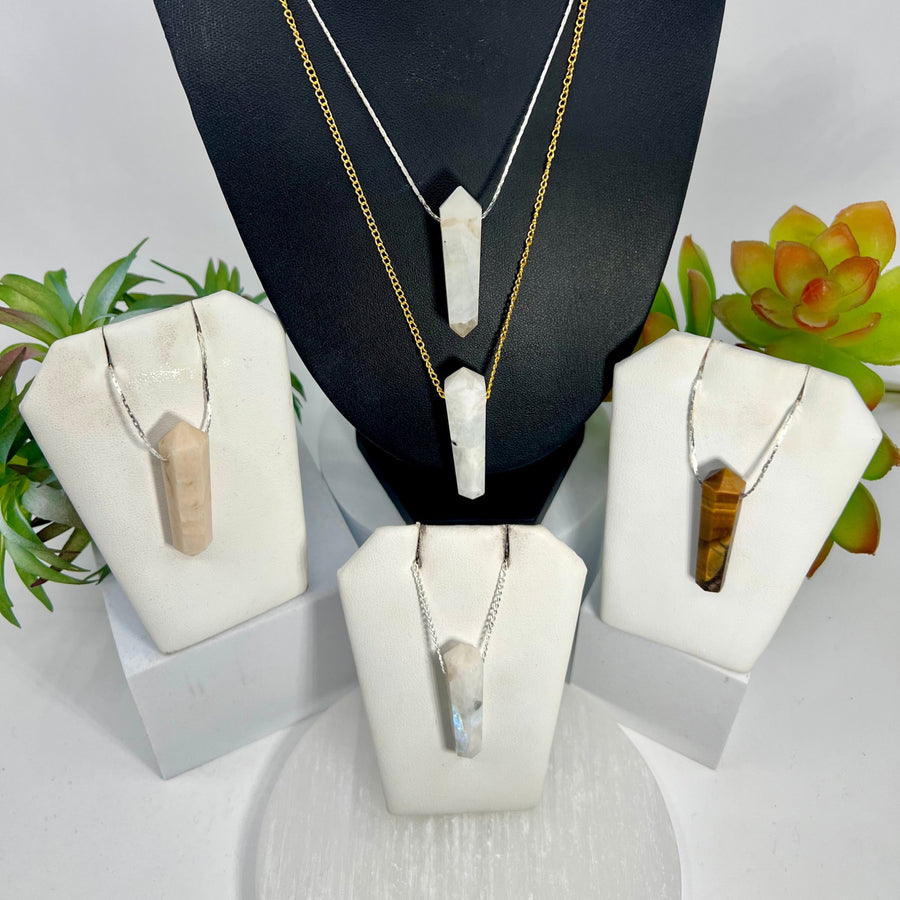 Crystal point pendant necklaces featuring double terminated mini wands on chains in various stones