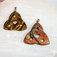 Two crystal triquetra pendants: golden tiger eye and red jasper, 1.5 inch