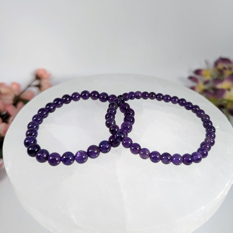 Purple beaded bracelets featuring dark amethyst 5mm or 6mm beads on a 7-inch bracelet