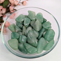 Bowl of polished dark green aventurine tumbled stones for prosperity and healing