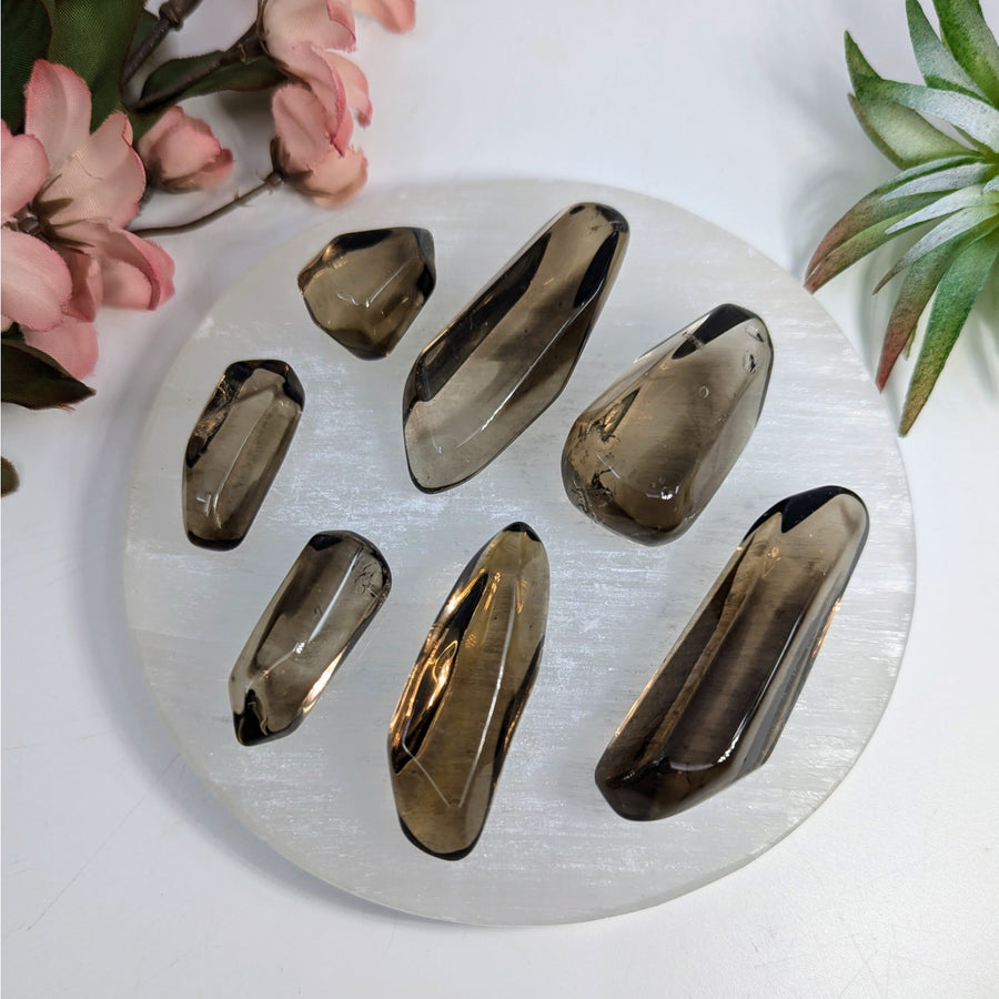 Seven smoky quartz tumbled crystals showcasing dark smoky quartz for strong grounding connection