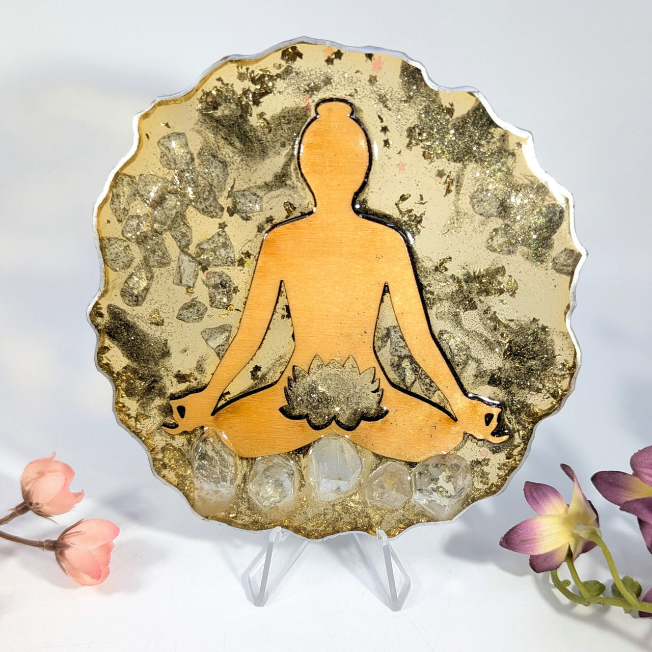 Golden meditative lotus plaque with quartz crystals on glittery background