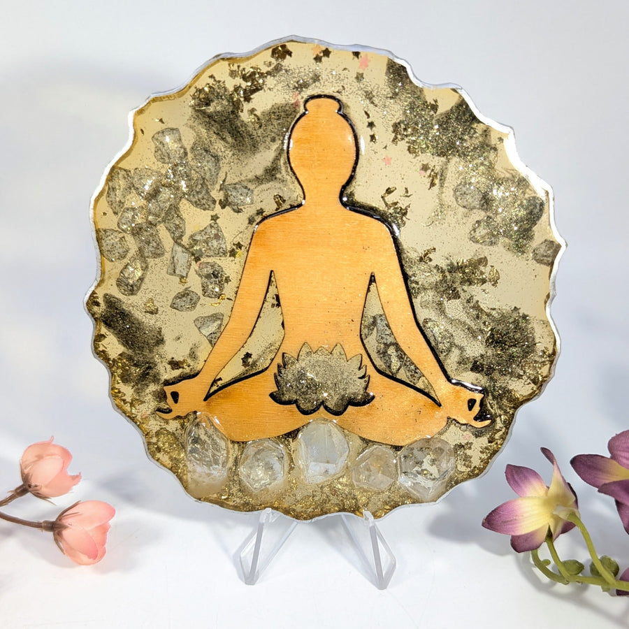 Golden meditative lotus plaque with quartz crystals on glittery background
