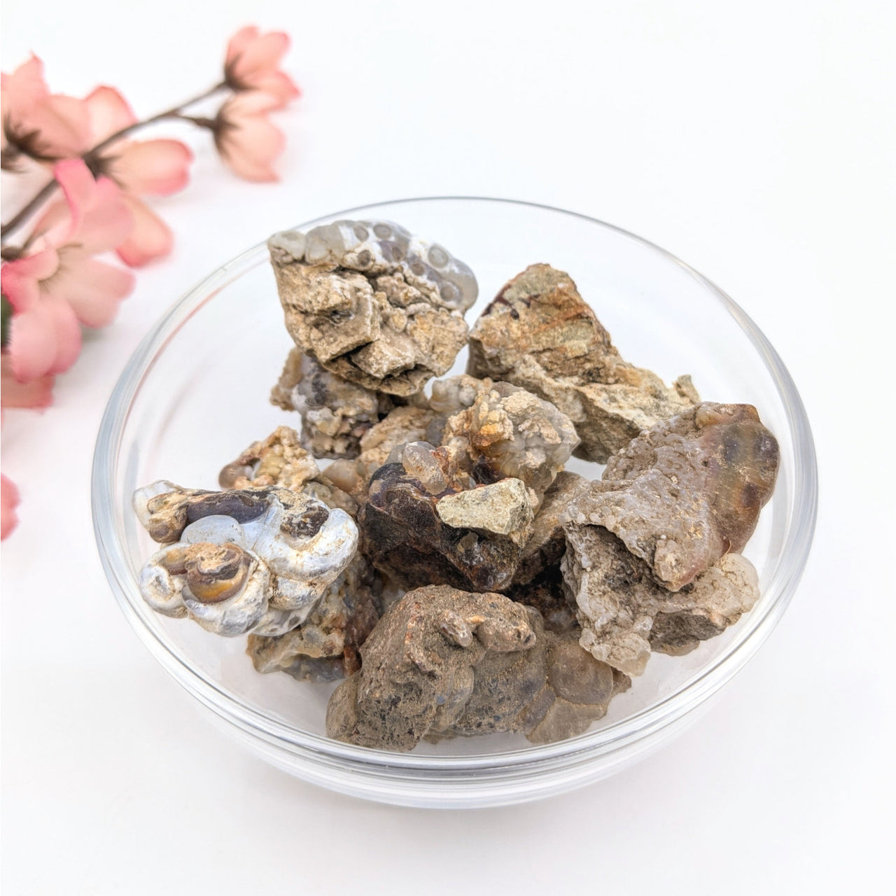 Deer Creek Fire Agate mixed size rough mineral specimens in glass bowl