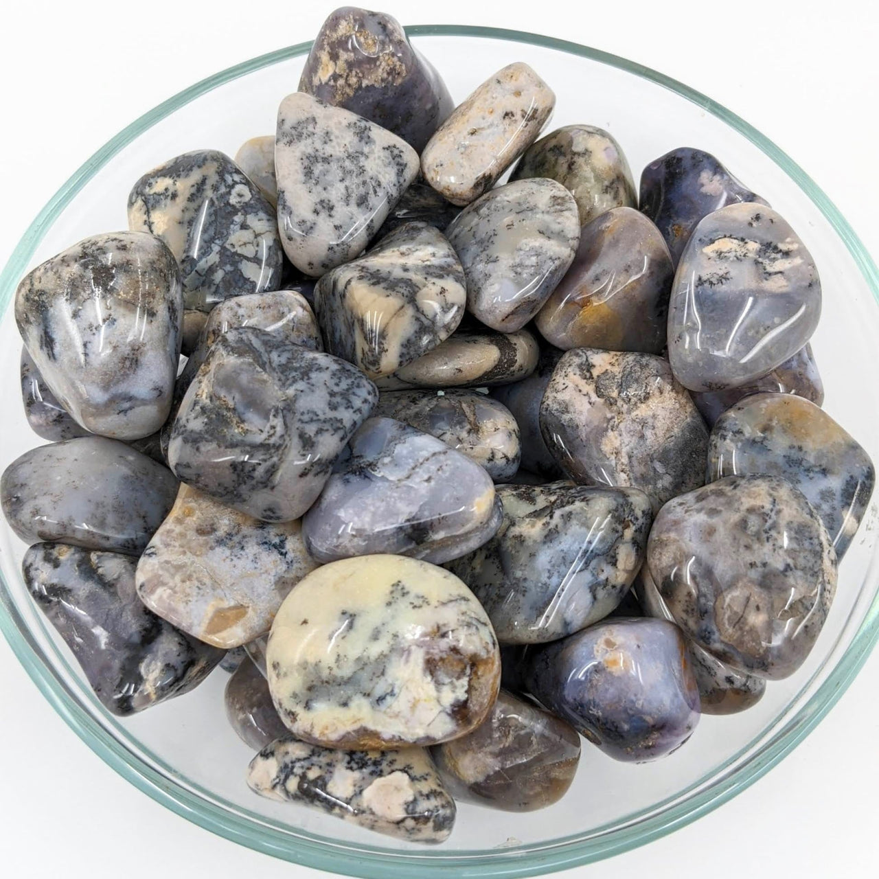 Close-up of Dendrite Agate Tumbled Stones in a bowl on a white surface, SKU #SK6883