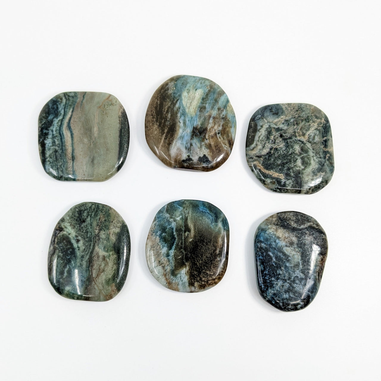 Six polished moss agate flat palm stones arranged in two rows, perfect for healing