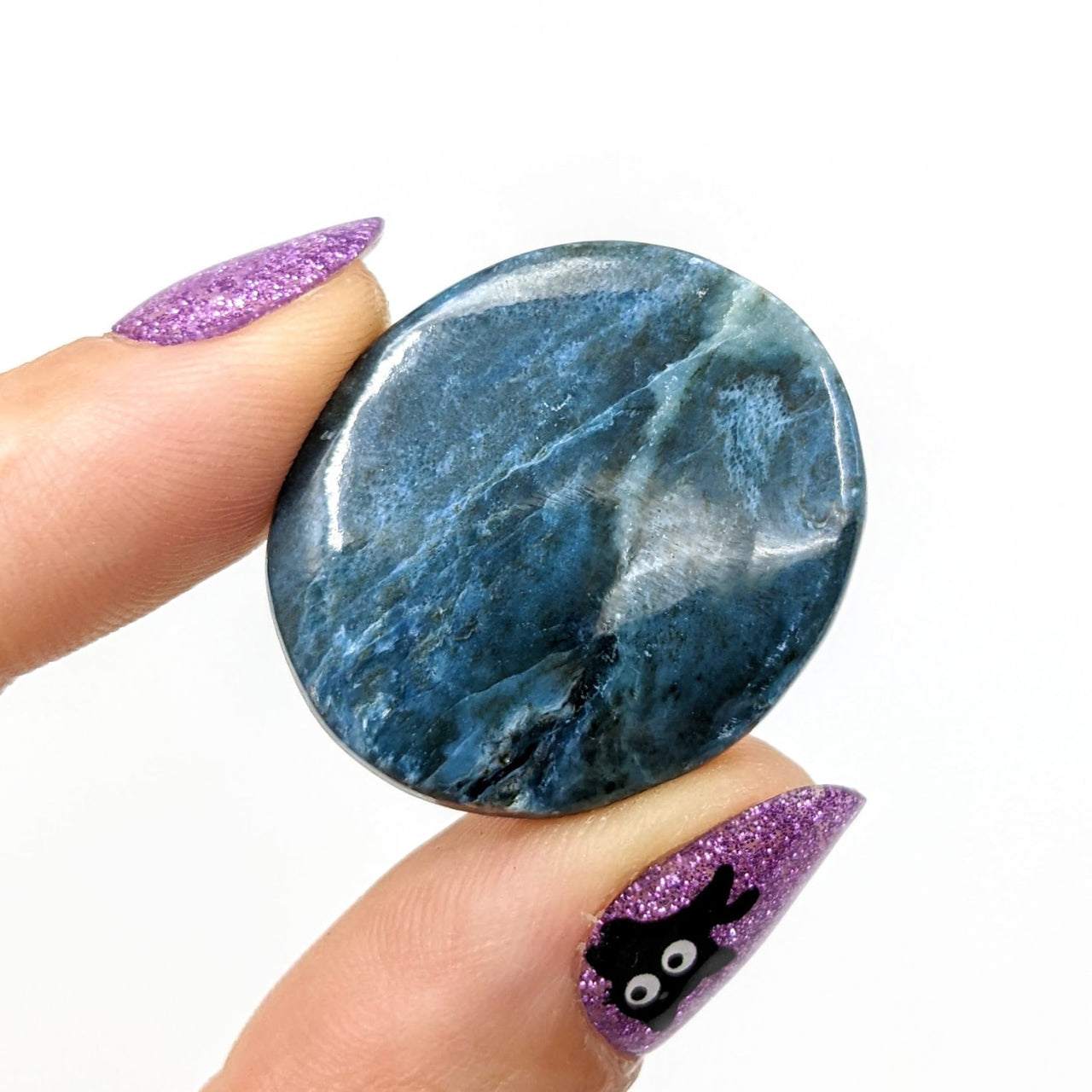 Person holding Dianite Grade AA 1.2’ Cabochon marble ring, blue and purple #LV1235