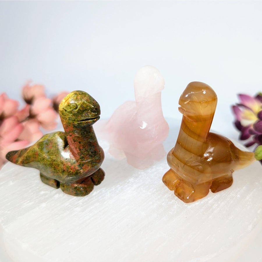 Hand-carved unakite and agate dinosaur figurines in green-red and amber tones