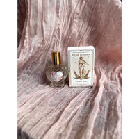 Heart-shaped Divine Feminine Coconut Vanilla perfume roller in glass bottle with gold cap and etched label, beside branded box, 15 ml #LV9591