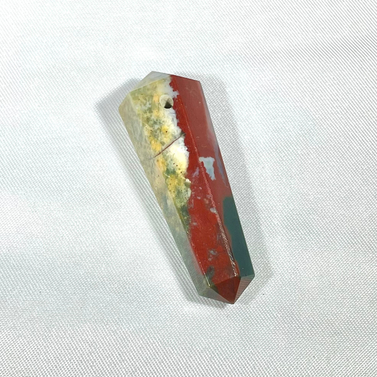 Double terminated crystal point pendant with red and green mineral inclusions