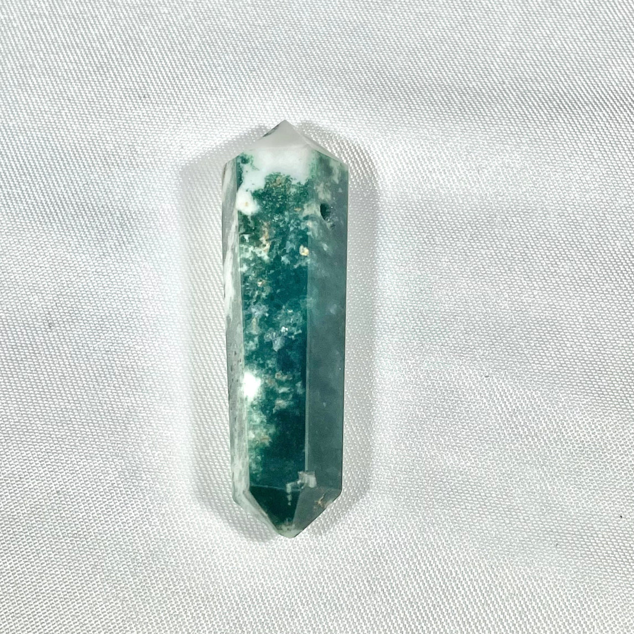 Double terminated crystal point pendant with green inclusions and clear structure