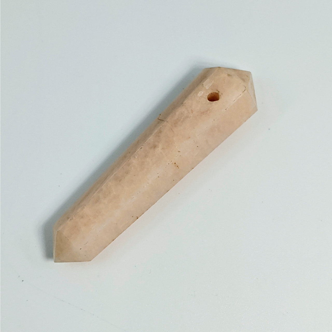 Peach-colored double terminated crystal point pendant with drilled hole for jewelry