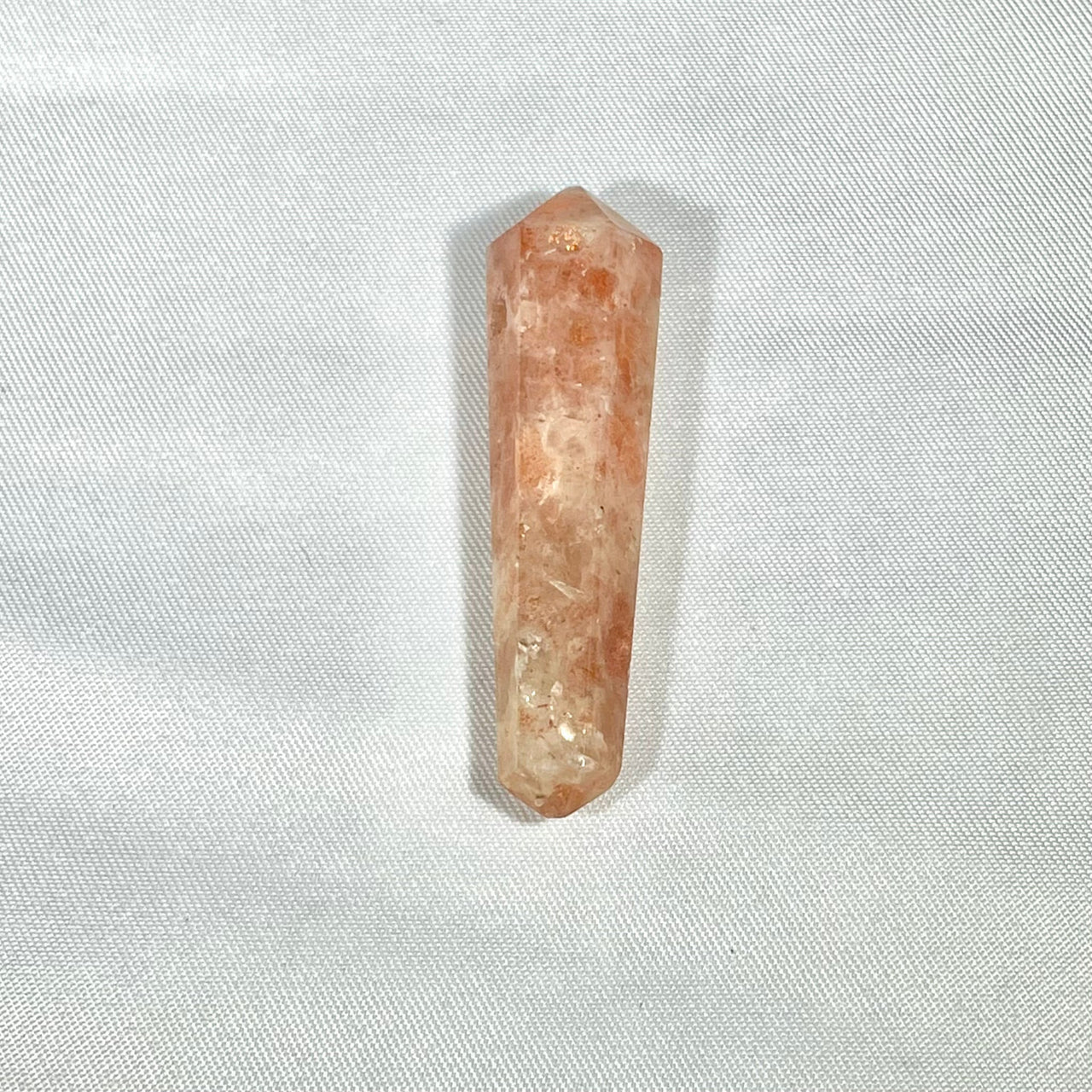 Pink-orange double terminated crystal point pendant showcasing natural raw texture