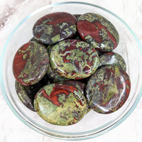 Thumbnail for Dragon’s Bloodstone Thumb Stone with Palm Stones in a bowl filled with pest-covered pests