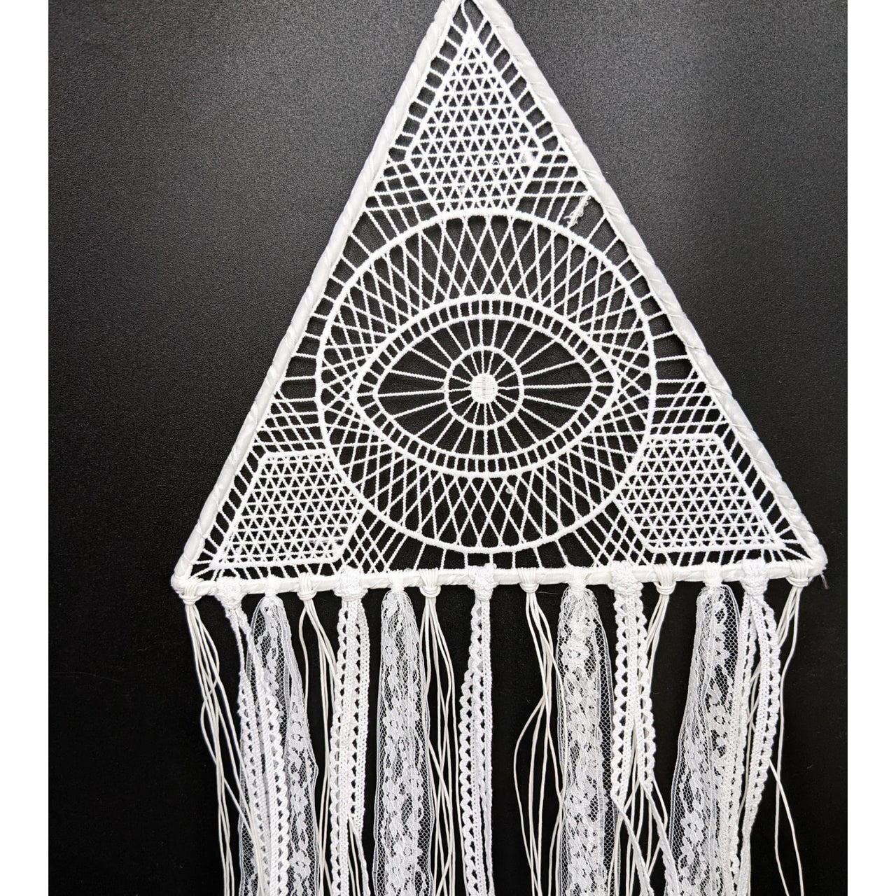 White crocheted triangular wall hanging with eye motif and lace tassels dreamcatcher 10 inch triangle white lace