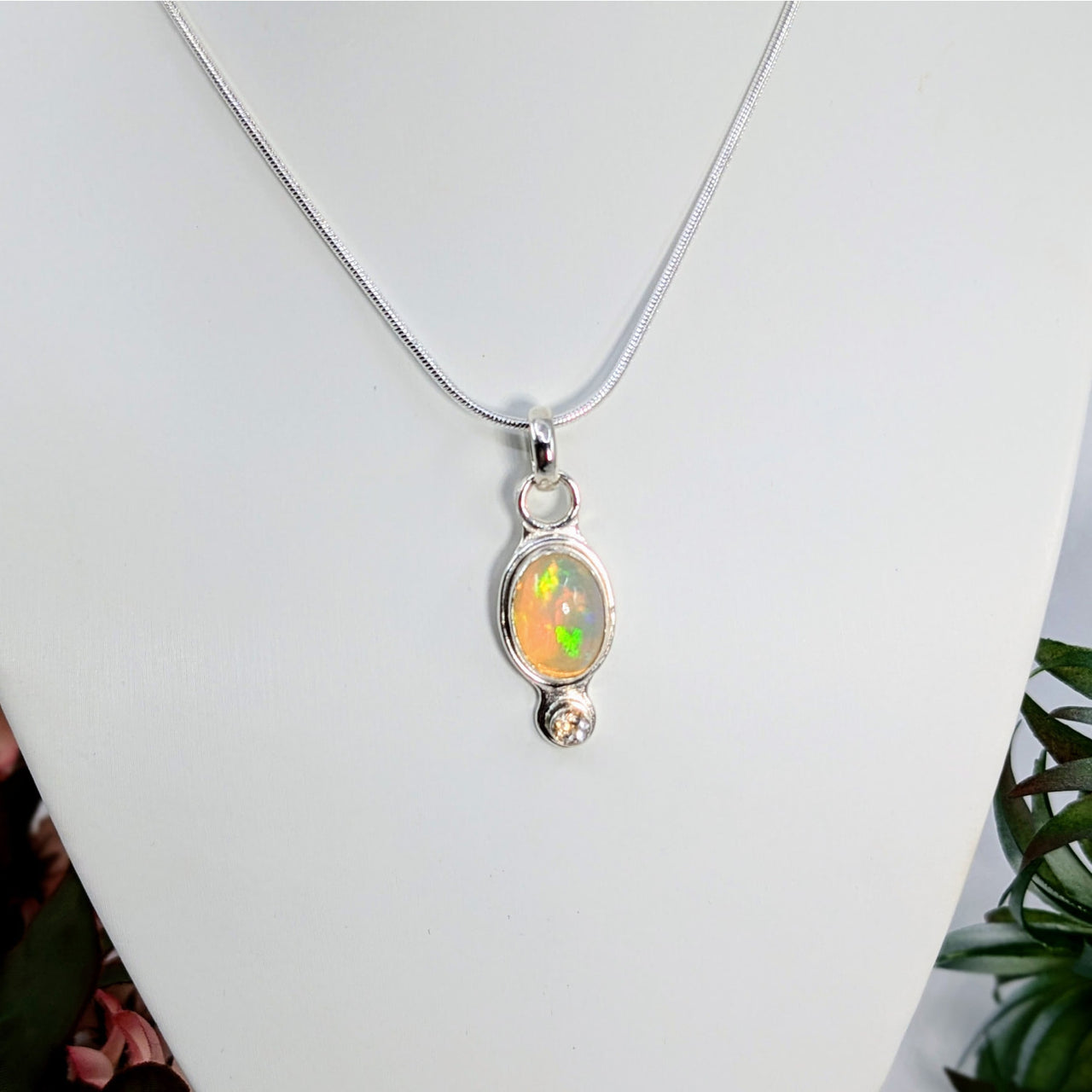 Silver Ethiopian Opal Pendant with Clear Quartz and Iridescent Oval Stone