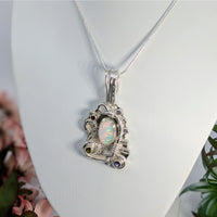 Thumbnail for Ornate Ethiopian opal pendant with silver scrollwork and garnet, peridot, tanzanite accents