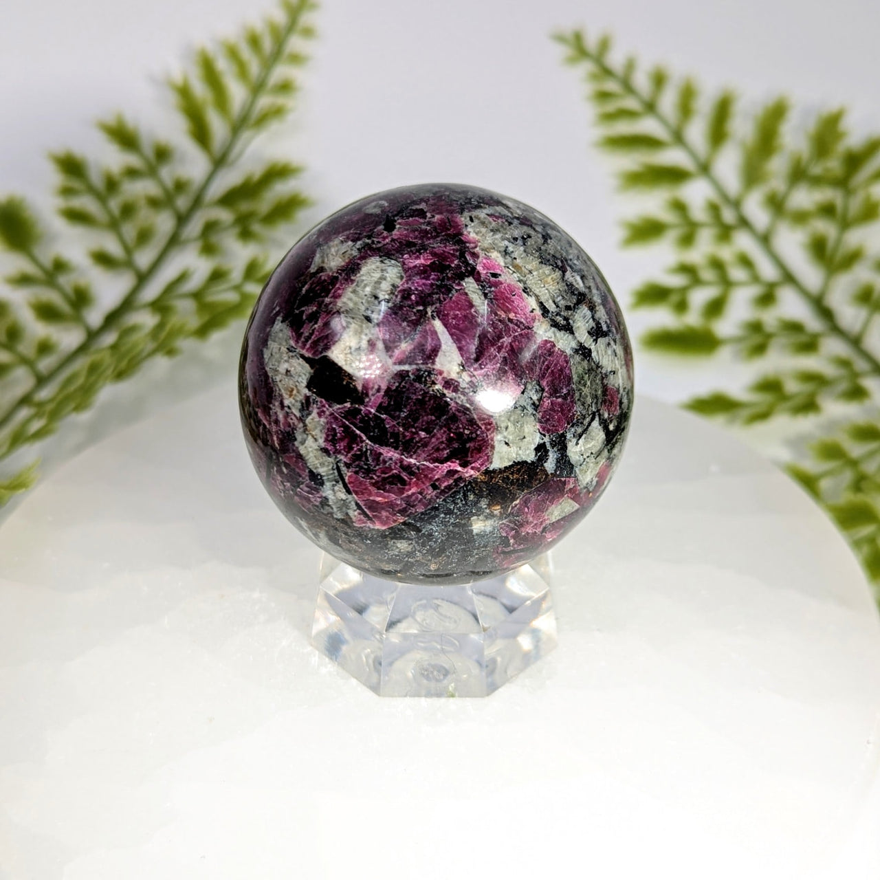 Eudialyte AA 2-inch sphere #BC0908 with magenta gray swirls on crystal stand