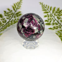 Eudialyte AA 2-inch sphere #BC0908 with magenta gray swirls on crystal stand